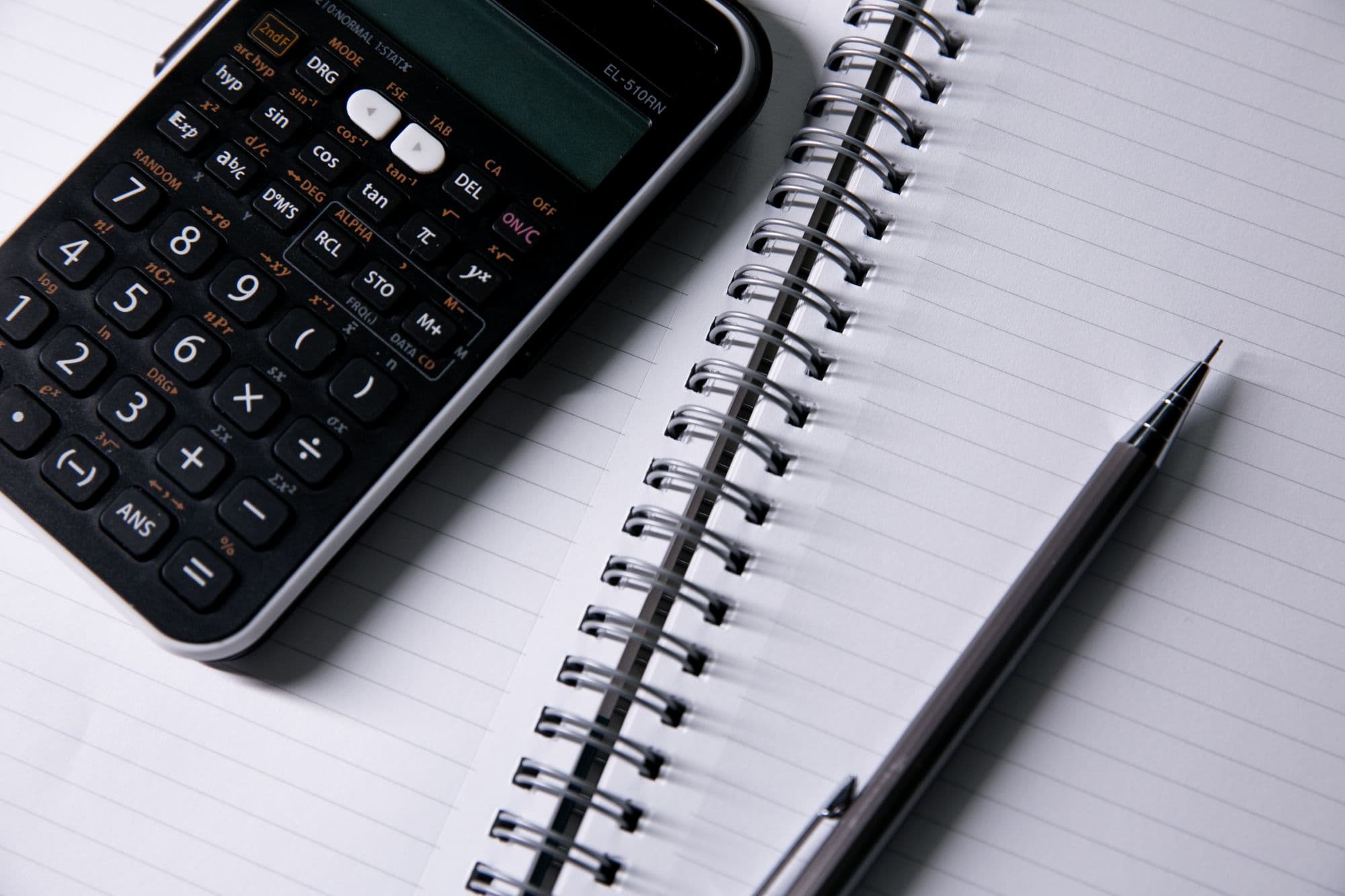 Notebook and calculator used to document accounting work