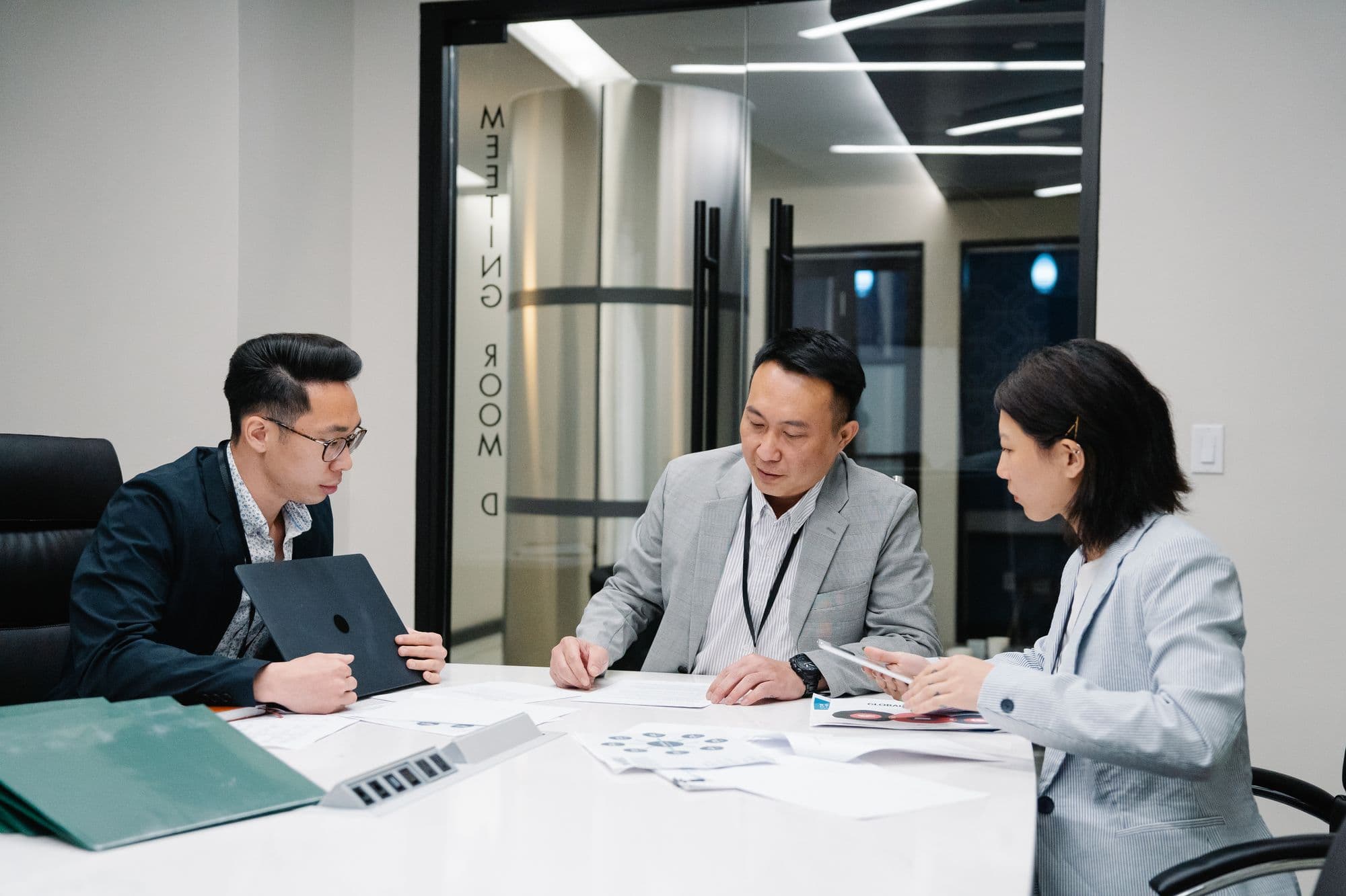 Three colleagues meeting in a conference room